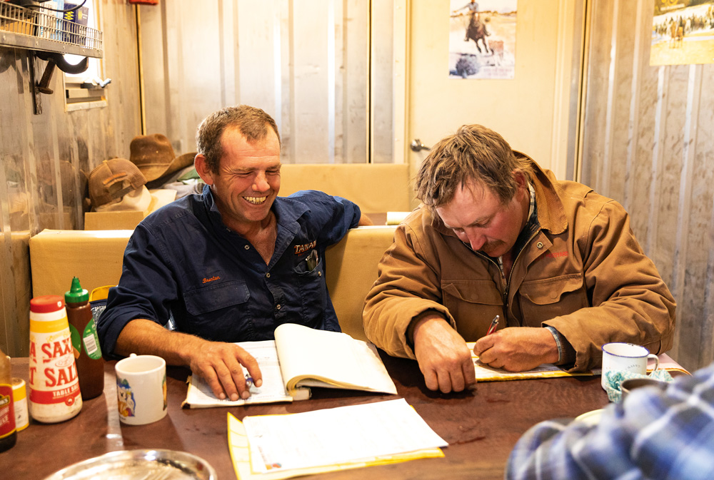 Clifton Hills station manager Pete Nunn (at right) completes paperwork with Brenton Oldfield, before cattle are Trucked out. Photo Georgie Mann. Stations Issue #128.