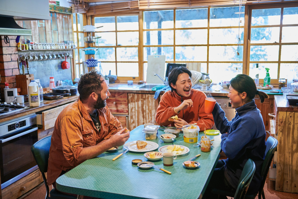 Professional mushroom forager Mark Foletta shares a meal with WWOOFers Daesoo and Yura in Victoria.